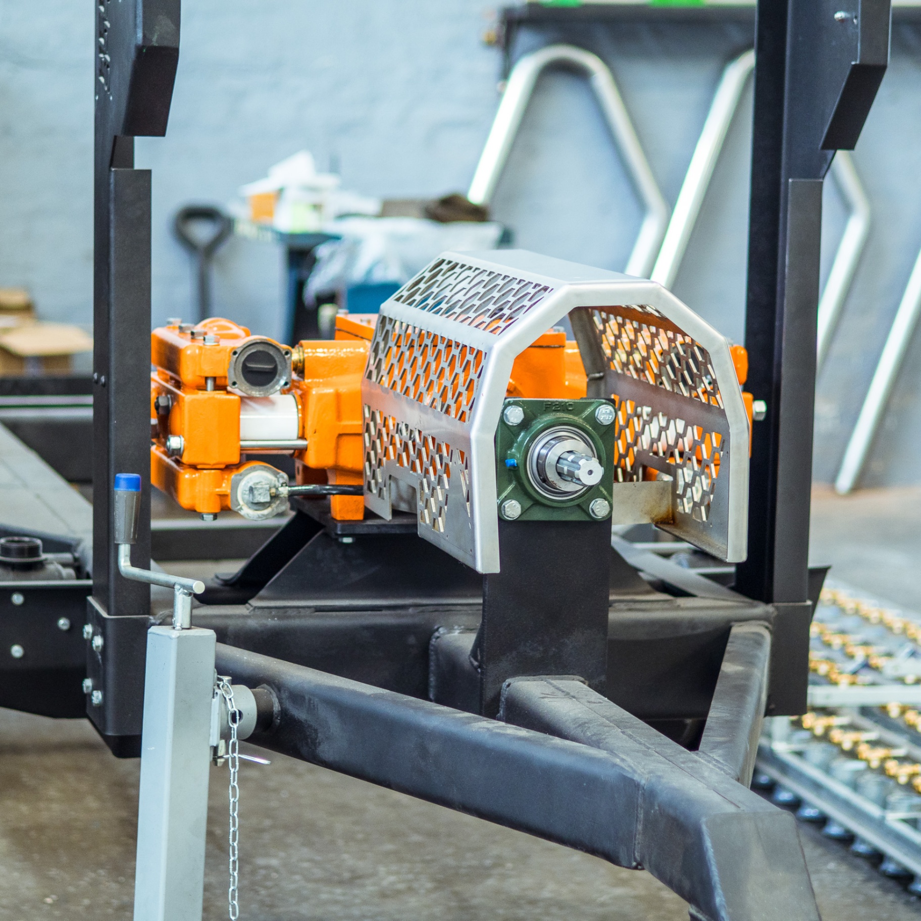 Newly assembled orange gearbox and drive guard on a Turn-Rite trailer chassis