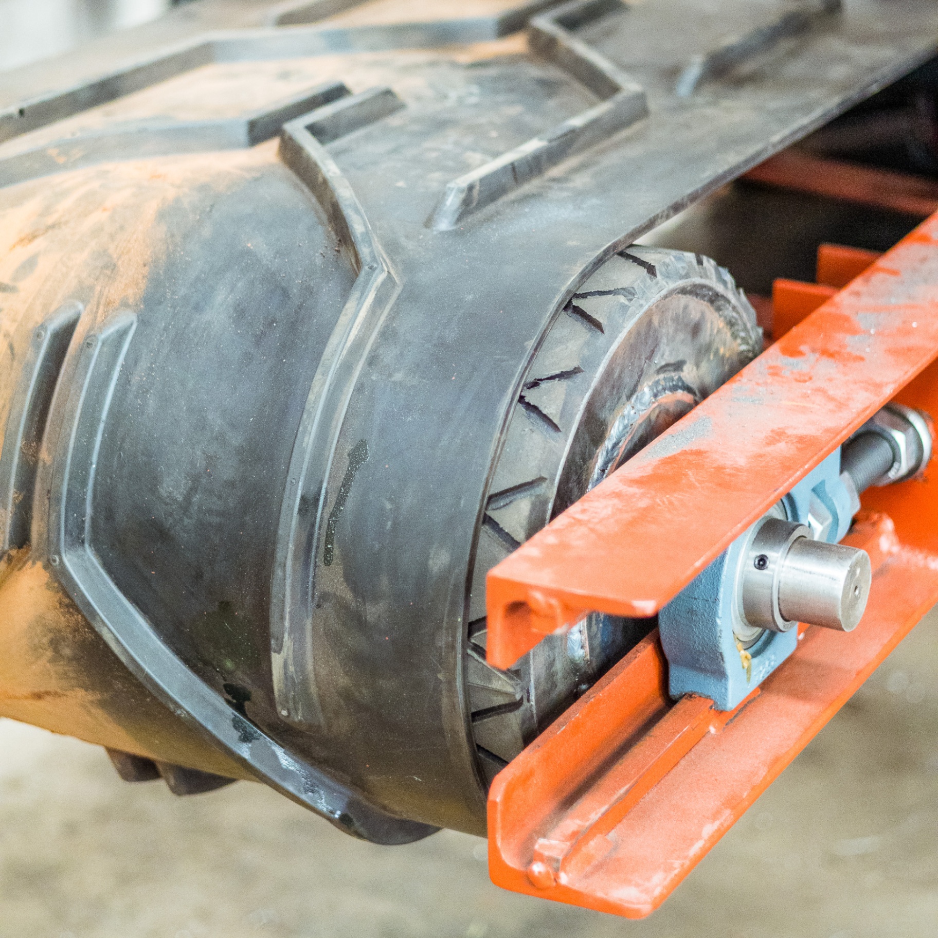 Close-up of a black fan or impeller housing mounted on an orange test rig