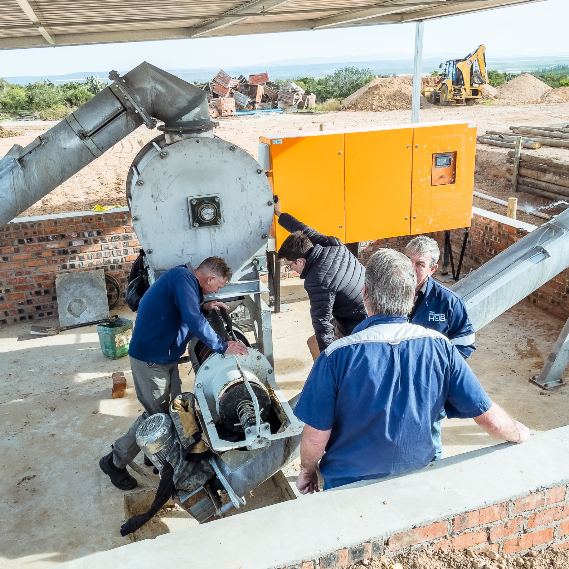 Turn-Rite team commissioning a fan and conveyor installation on a farm