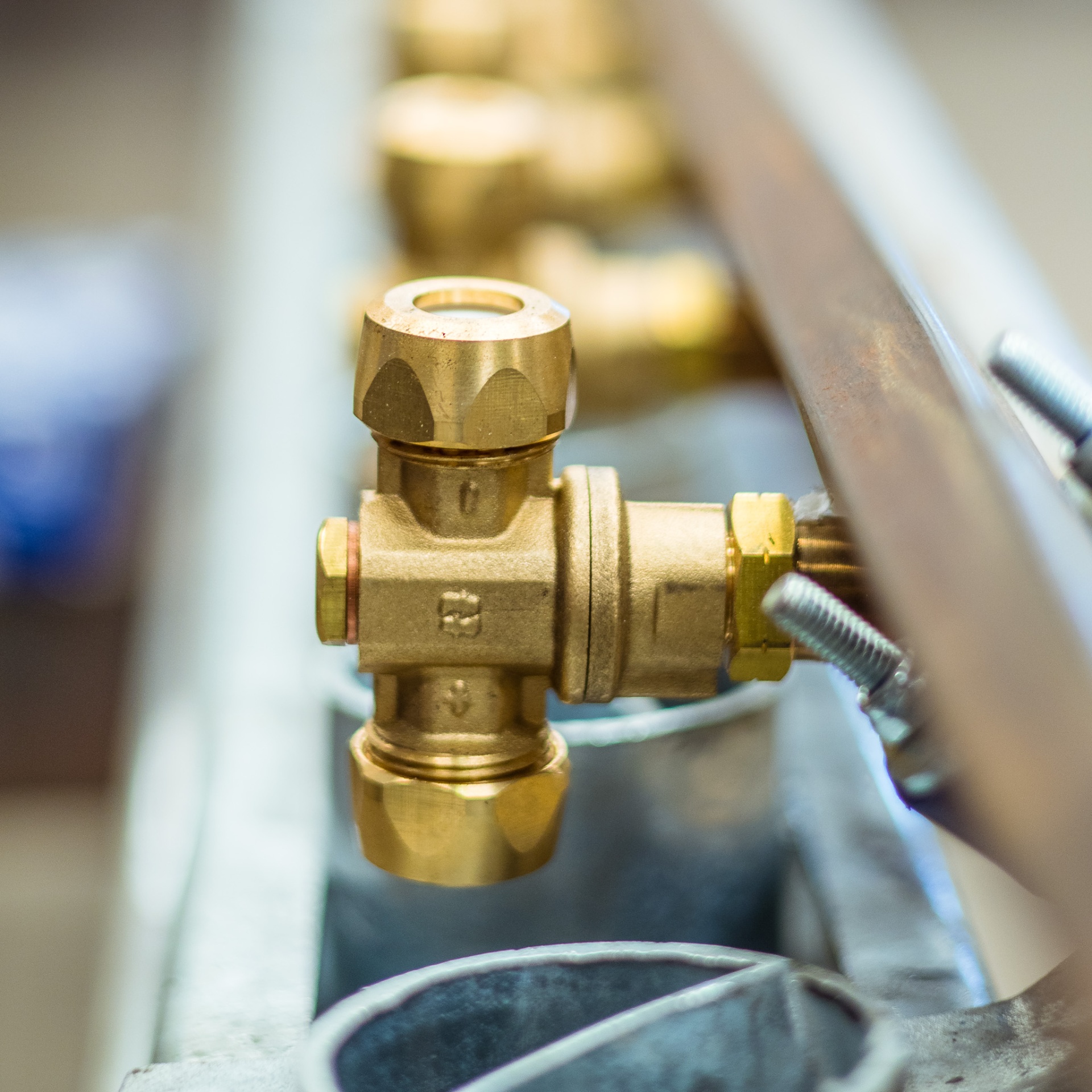 Detailed brass valve fitting mounted within industrial equipment
