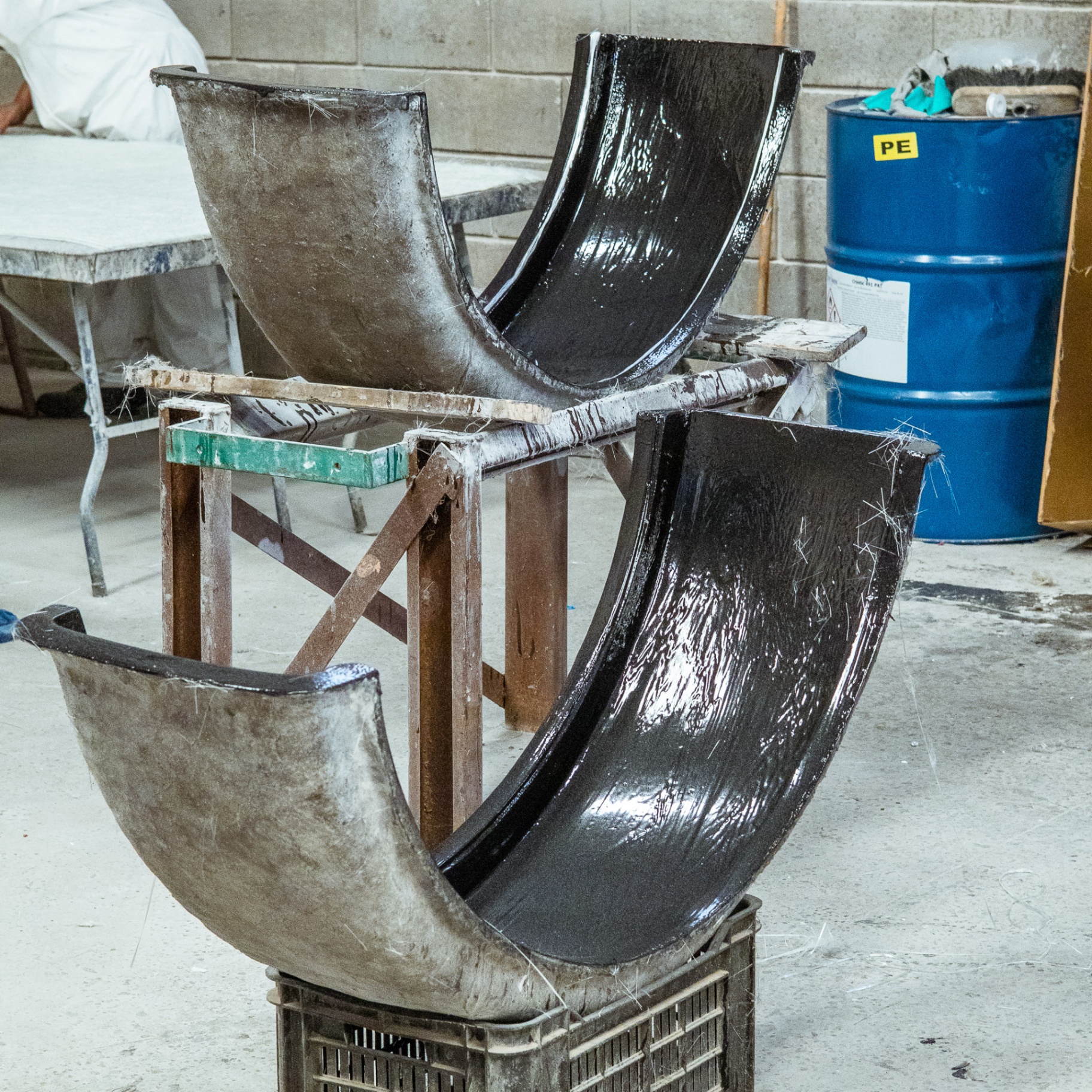 Freshly moulded black fibreglass components curing in the workshop