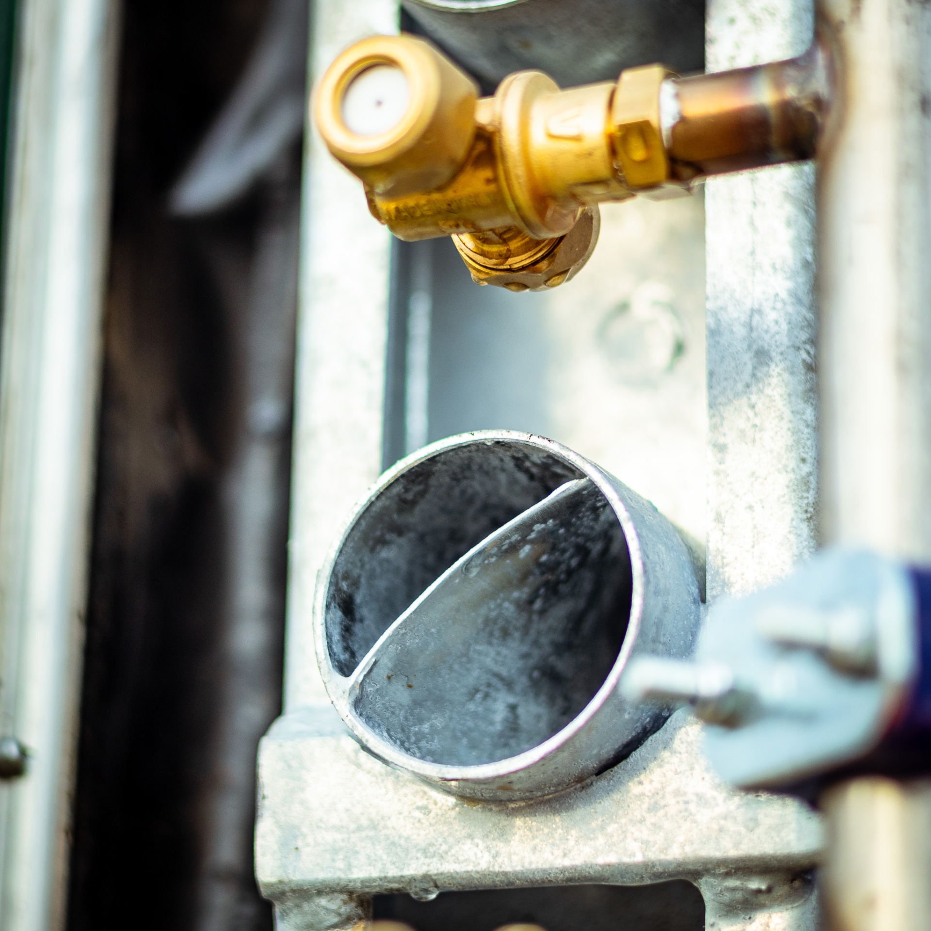 Close-up of brass valve and galvanised spray nozzle assembly