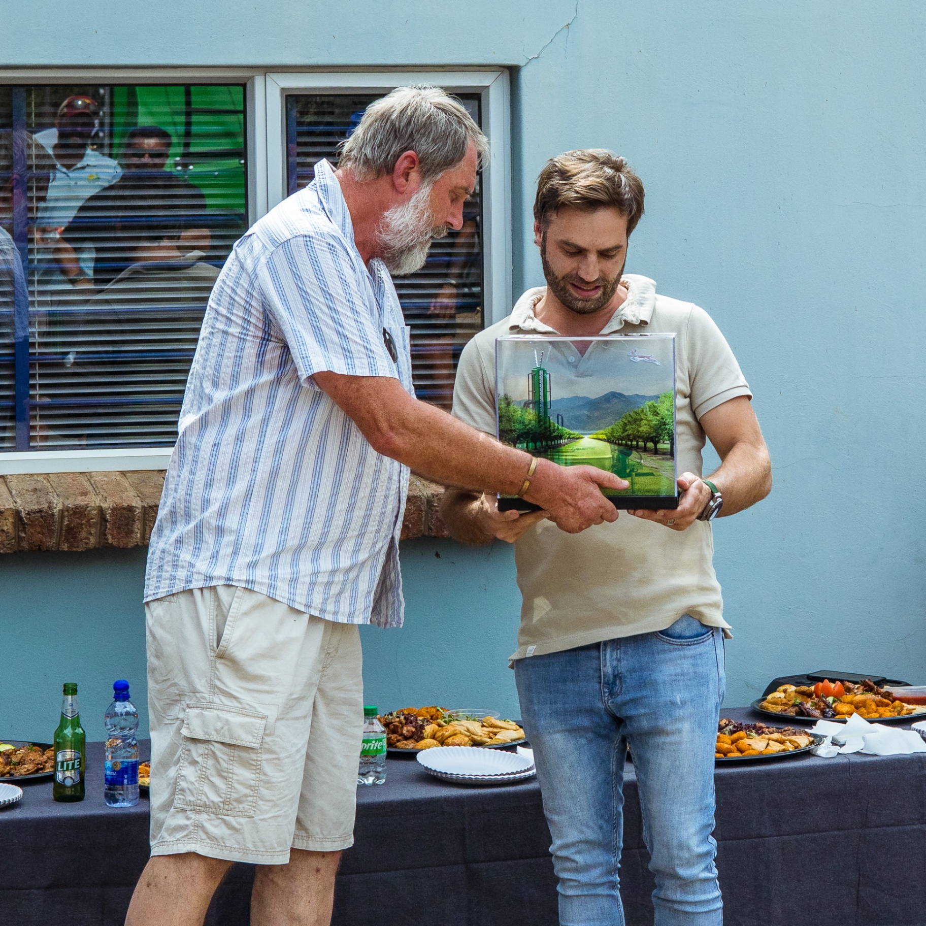 Turn-Rite team presenting a framed image during an outdoor gathering