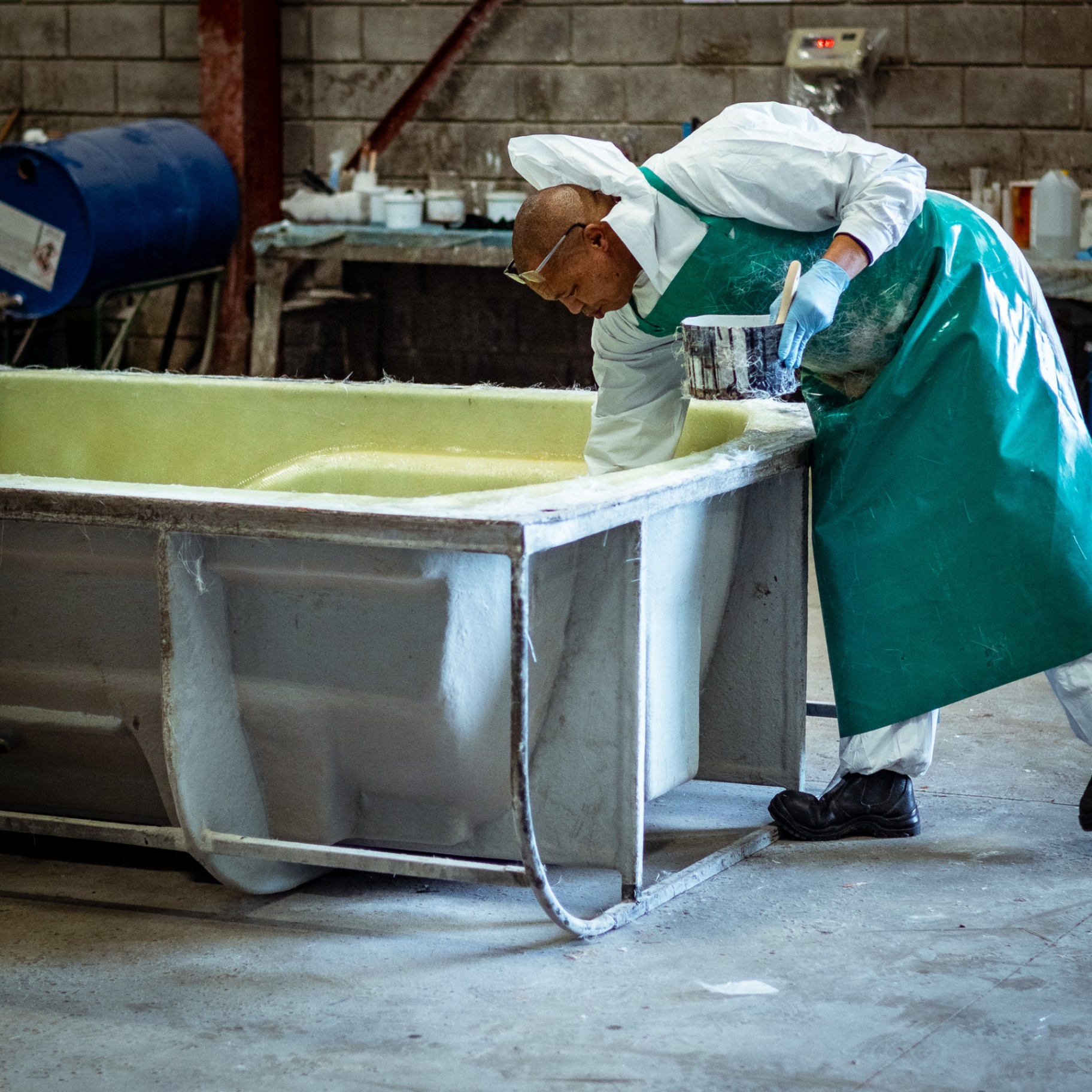 Technician laying fibreglass inside a moulded tank at Turn-Rite